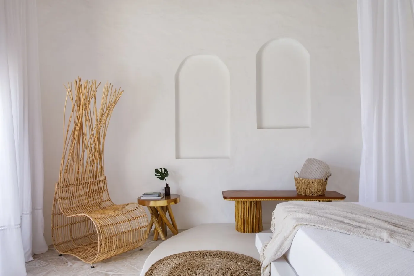 Master Bungalow: bedroom with arched niches and a sculptural fibre chair