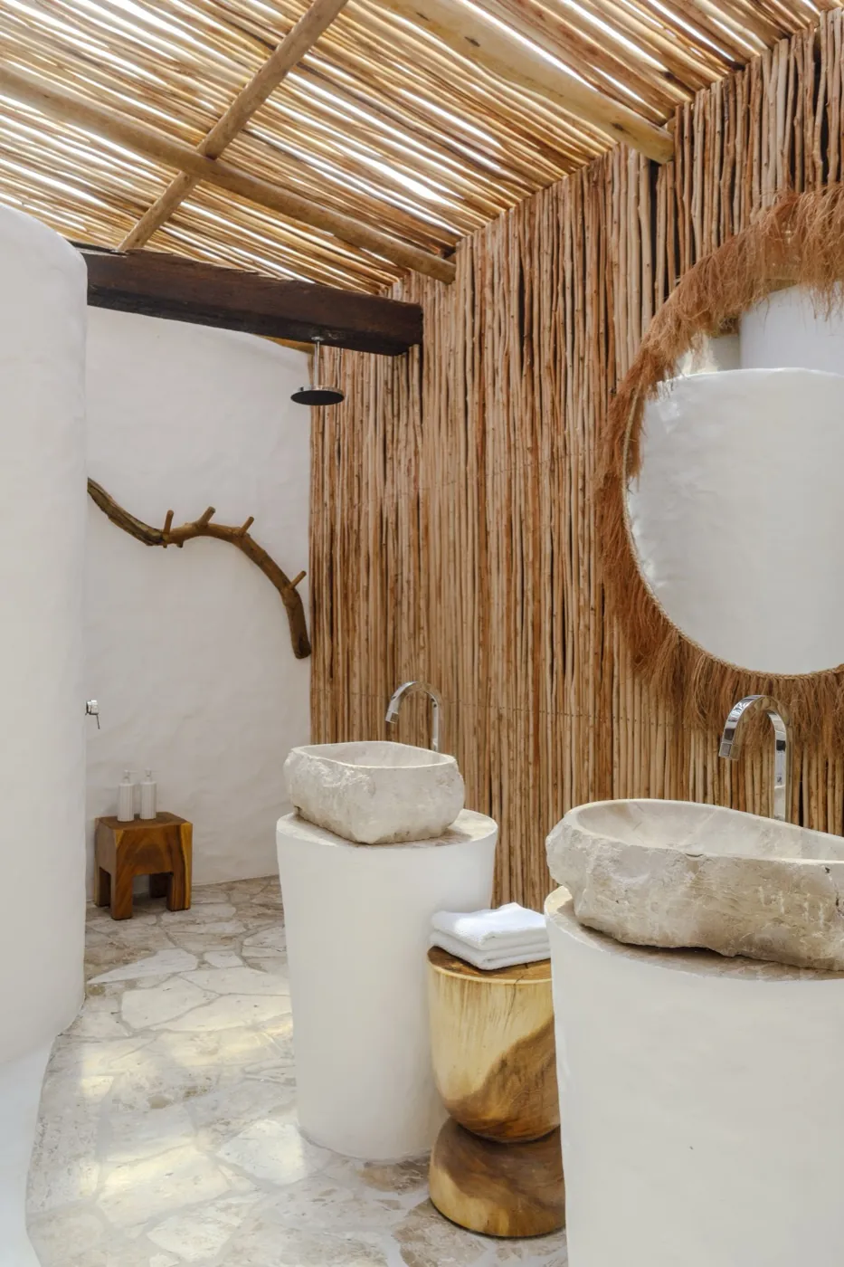 Master Bungalow: bathroom with two stone sinks and a fibre wall