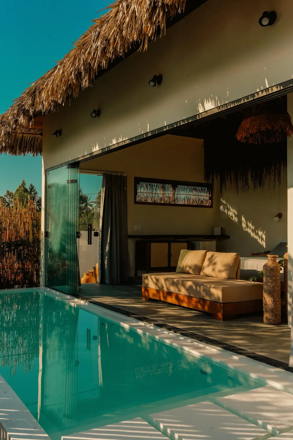 Private Chalet: glass wall, private pool and living area at sunset